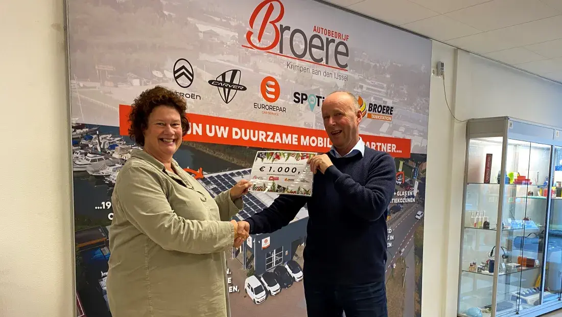 Piet Broere (Autobedrijf Broere) overhandigt cheque aan Arjenne Timmer (Stichting Dagbesteding Krimpenerwaard)